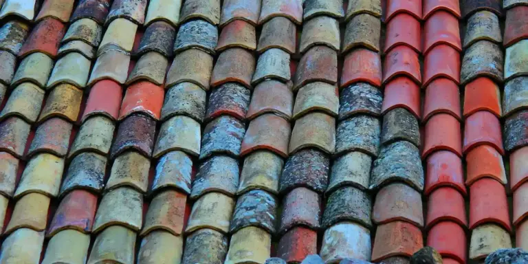 Close-up of multicolored clay roof tiles arranged in neat rows