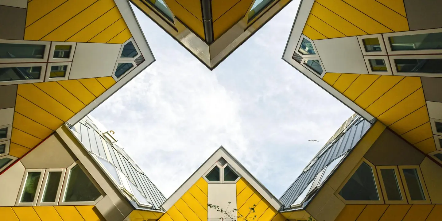 Geometric view of yellow metal roof panels on residential buildings forming intersecting angular shapes