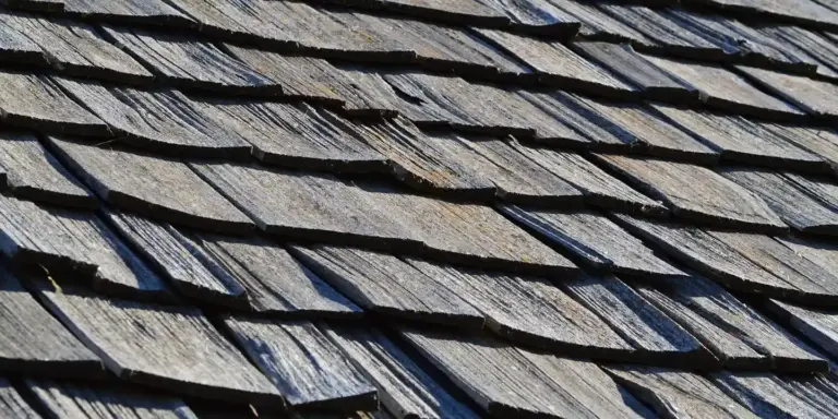 Weathered wooden shingles on a dormer roof