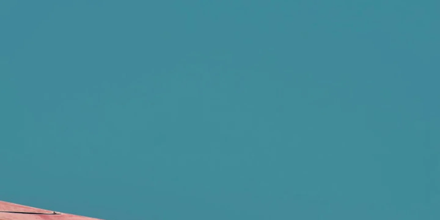 Edge of a flat roof against a clear blue sky