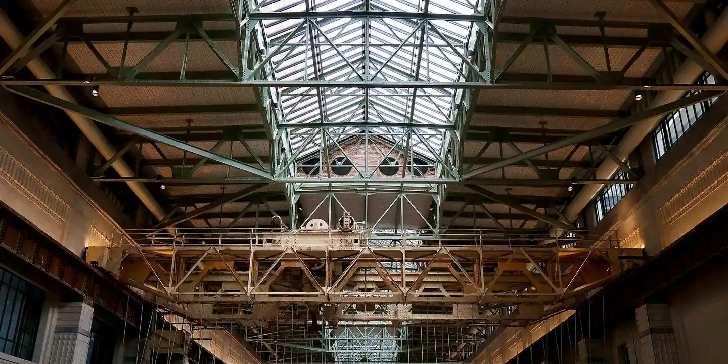 Interior view of a roof with exposed steel and wood trusses, showing complex framing that may require braces to support overhangs and porches.