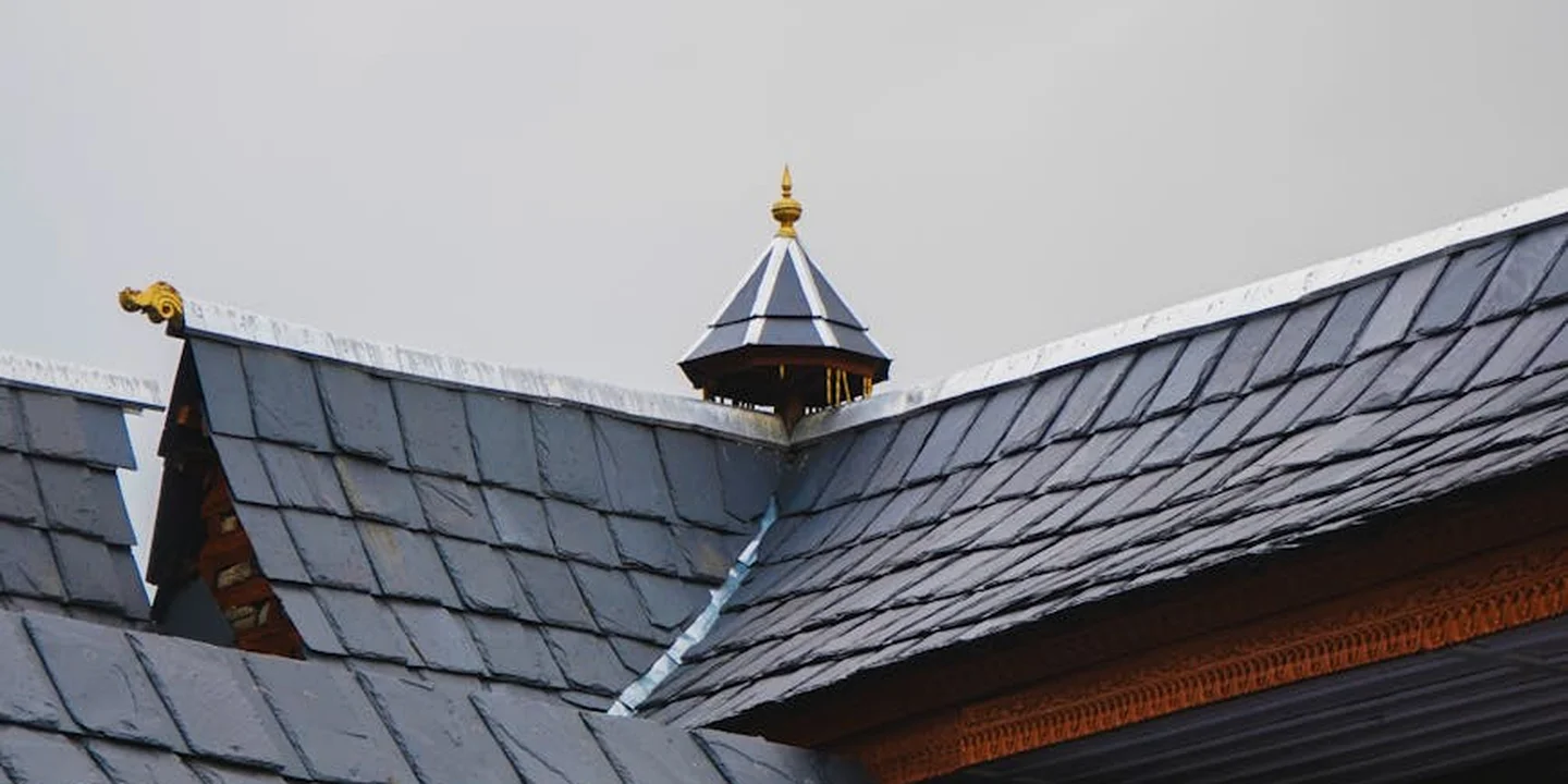 Residential metal roof with standing-seam panels on a house.