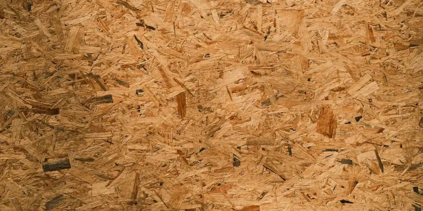 Close-up of OSB roof sheathing showing the textured wood strands