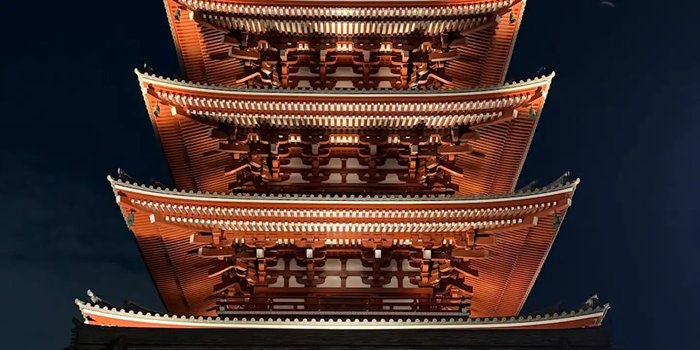 Night-time photograph of a multi-tier wooden pagoda with illuminated eaves, highlighting timber framing techniques relevant to roof truss repair and reinforcement.