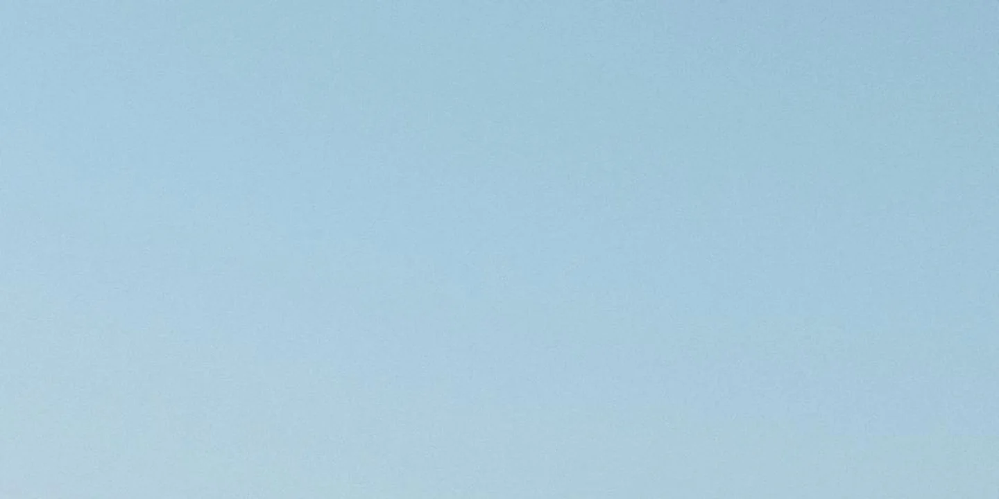 Clear blue sky with no visible roof, used as a header image for the roof rake discussion.