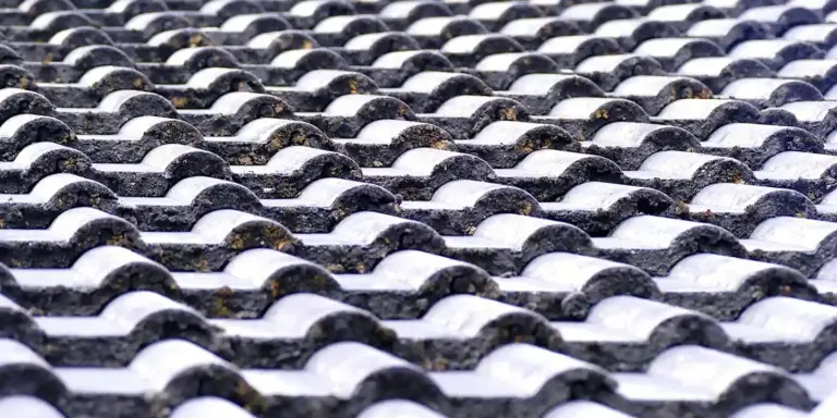 Close-up view of curved, overlapping roof tiles in a repeating pattern