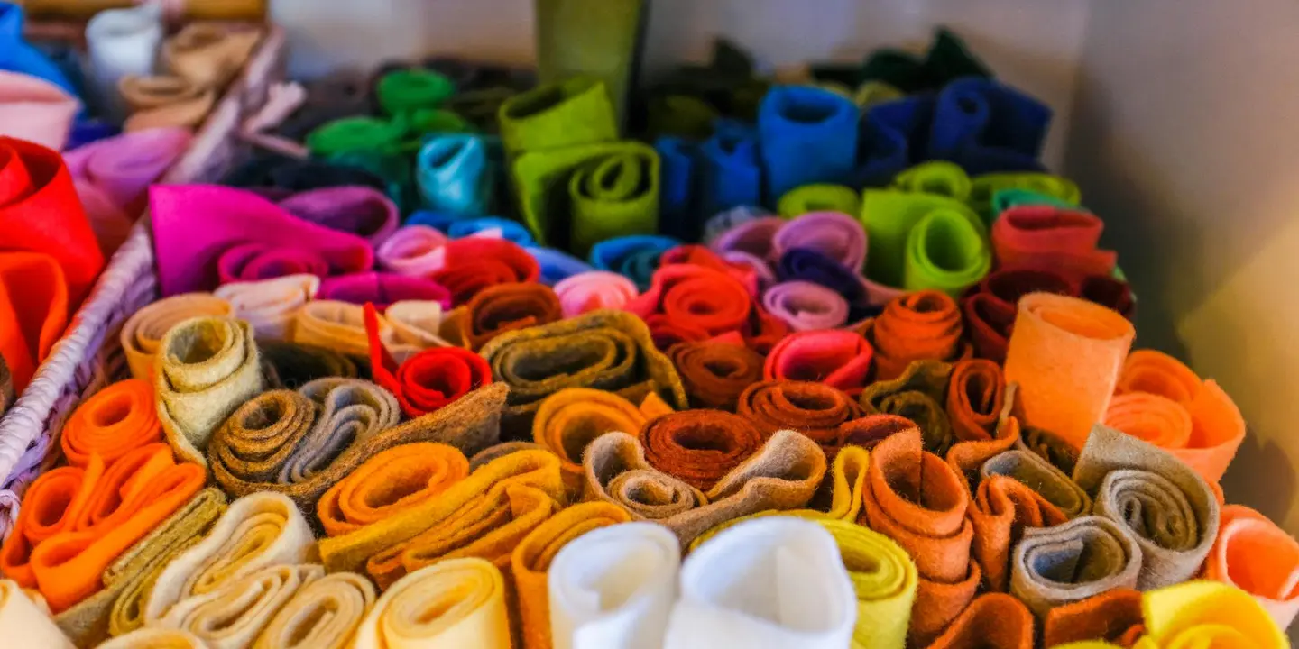 Assorted rolls of colorful roofing felt underlayment arranged together, ready to start the first course on a residential roof deck.
