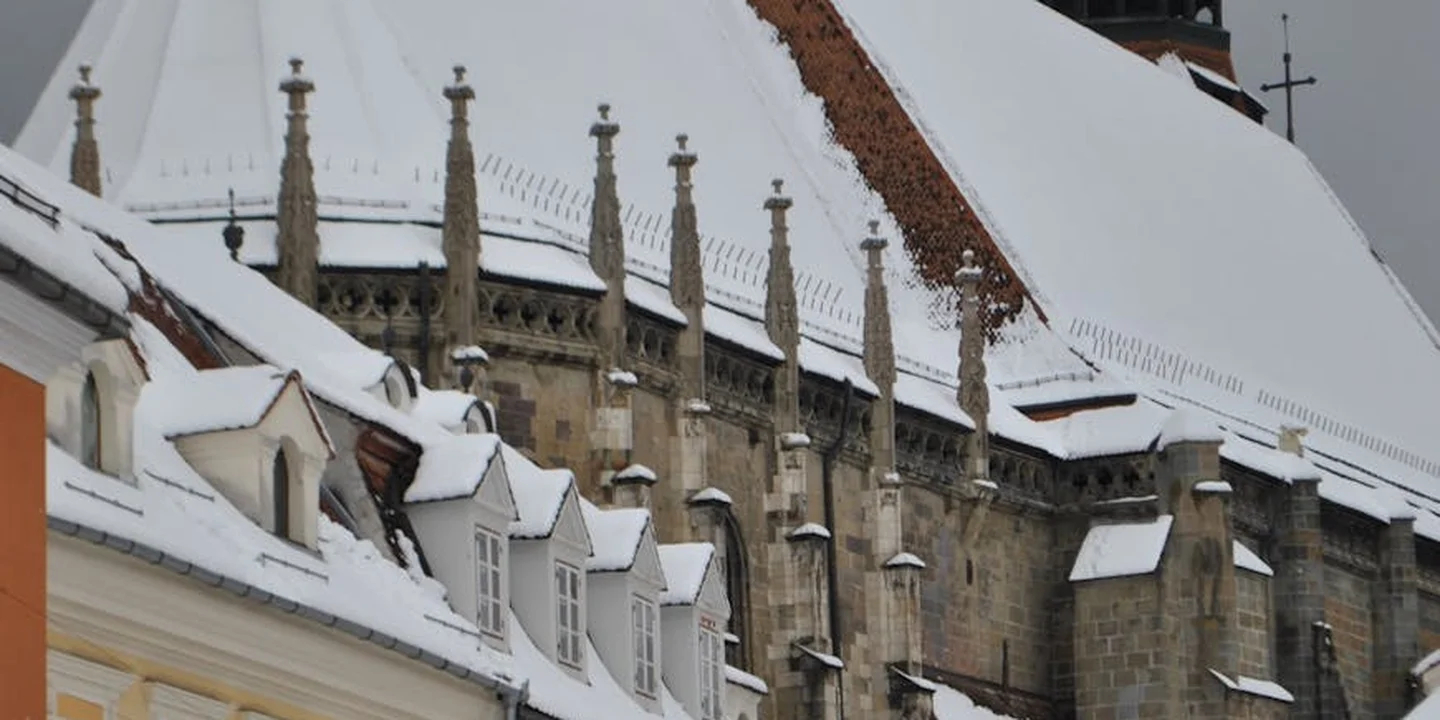 Snow-covered roof with ridge vents and dormers illustrating roof ventilation components