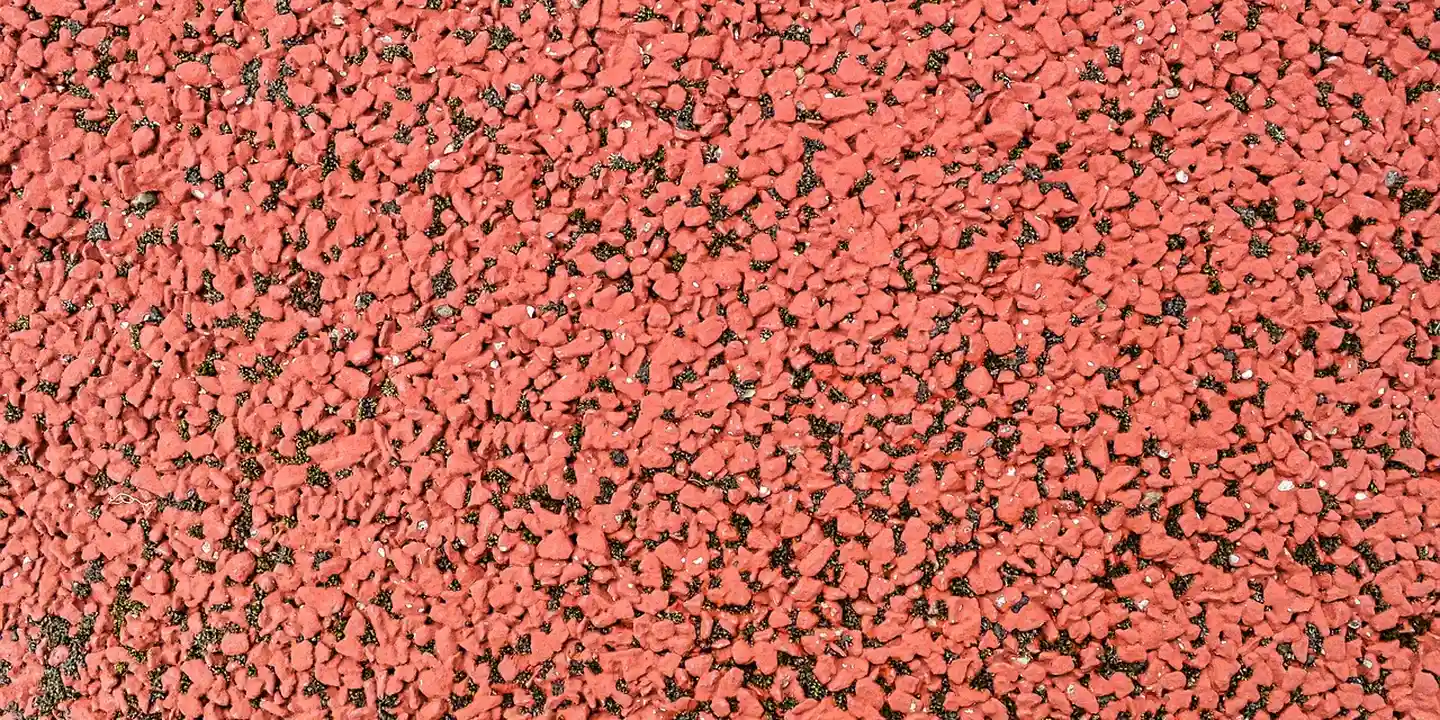 Close-up of a granule-covered residential roof surface, illustrating areas around valleys, vents, and chimneys.