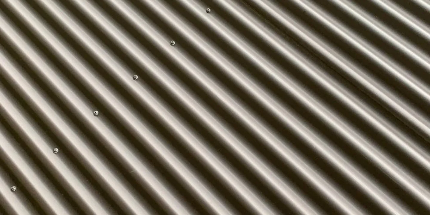 Close-up of corrugated metal roofing panels with evenly spaced ridges