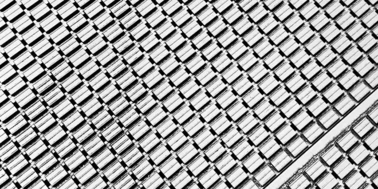 Close-up of a metal roofing panel with a diagonal grid pattern.