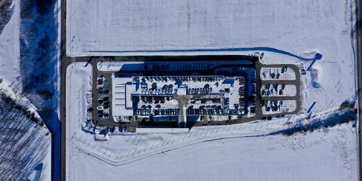 Aerial view of a snow-covered flat roof area on a building complex.