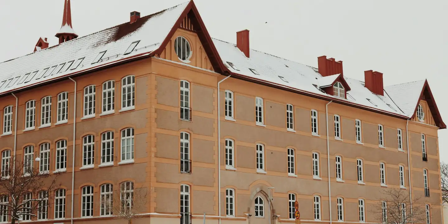 Brick building with a snow-covered sloped roof